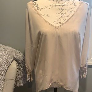 Beige bell sleeve blouse.